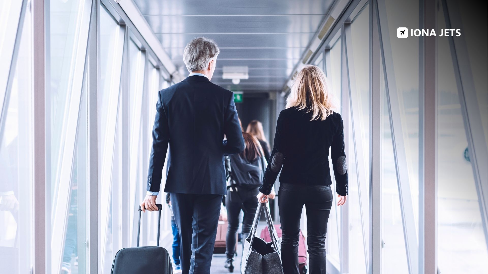 Corporate delegates walking through an airport jet bridge with luggage, boarding a chartered flight for a MICE conference and incentive travel program.